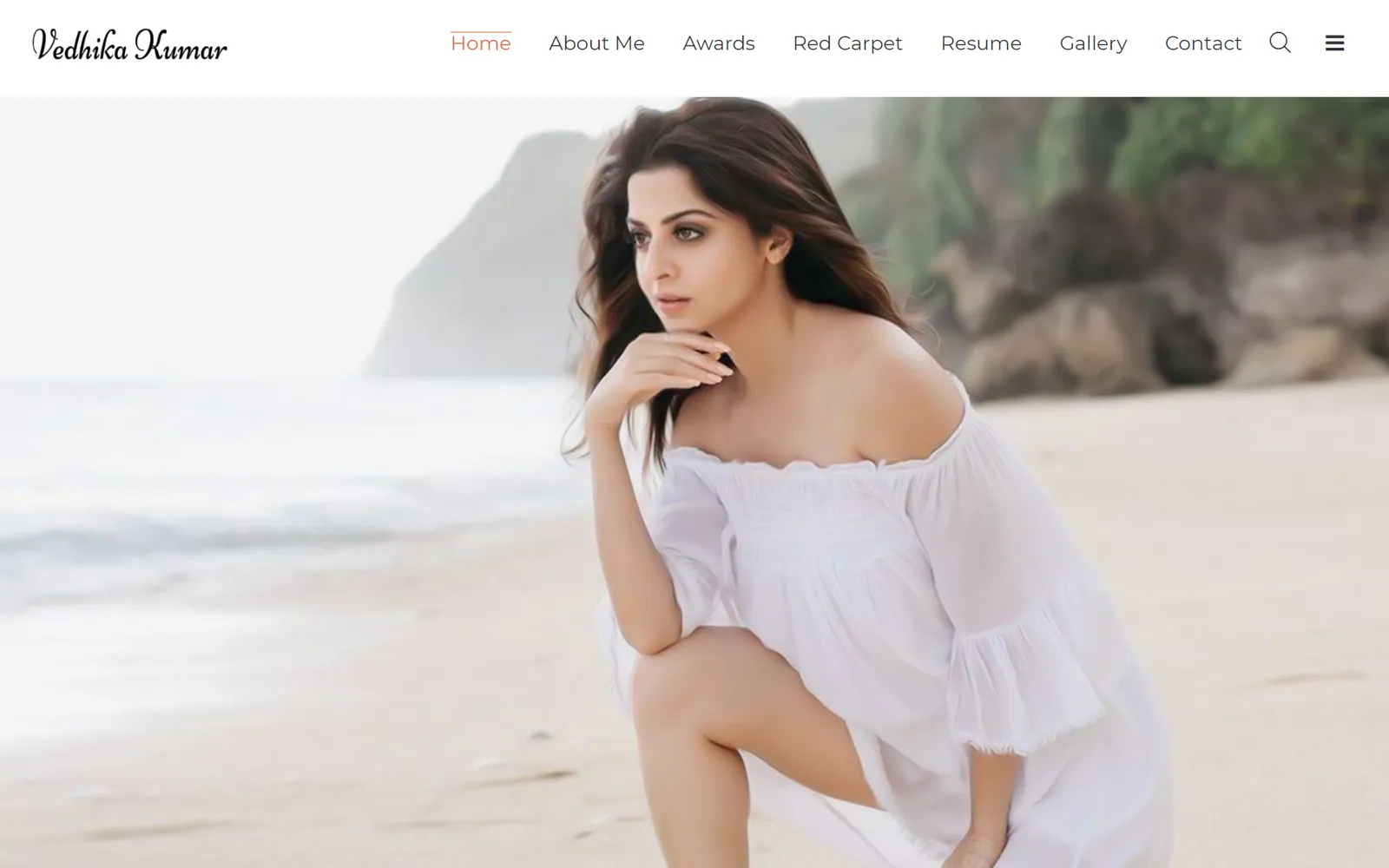 Vedhika Kumar's official website, a full width beach portrait beneath a script logotype and simple navigation